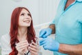 Doctor orthodontist shows a woman silicone aligners to straighten teeth Royalty Free Stock Photo