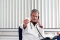 Doctor overstressed at his office desk