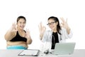 Doctor and overweight patient show OK sign