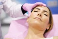 Doctor painting the area of a woman& x27;s face where the PDO suture treatment threads will be injected. Royalty Free Stock Photo