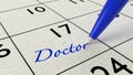 Doctor paper calendar entry and blue pen