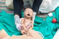 Doctor, paramedic, refresher training to assist childbirth newborn with medical dummy