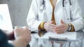 Doctor and patient consultation with clipboard and medication notes. Close-up view of unknown female doctor using a Royalty Free Stock Photo