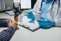 Doctor and patient in conversation about pill description, professional physician wearing white coat talking to mature woman Royalty Free Stock Photo