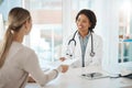 Doctor and patient discuss paperwork during medical consultation in a hospital. Healthcare professional, GP or physician Royalty Free Stock Photo