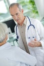 doctor and patient discussing at clinic Royalty Free Stock Photo