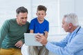 Doctor and patient discussing over digital tablet Royalty Free Stock Photo