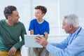 Doctor and patient discussing over digital tablet Royalty Free Stock Photo