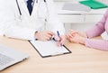 Doctor and patient are discussing something, just hands at the table, medical insurance Royalty Free Stock Photo