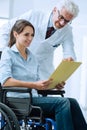 Doctor and patient examining medical records Royalty Free Stock Photo