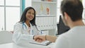 Doctor and patient having medical consultation shaking hands at the clinic Royalty Free Stock Photo