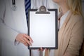 Doctor and patient holding clipboard free copy space. Medical ethics and trust concept Royalty Free Stock Photo