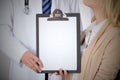 Doctor and patient holding clipboard free copy space. Medical ethics and trust concept Royalty Free Stock Photo