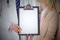 Doctor and patient holding clipboard free copy space. Medical ethics and trust concept Royalty Free Stock Photo