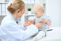 Doctor and patient in hospital. Little girl is being examined by pediatrician with stethoscope. Medicine and health care