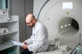 Doctor with a patient medical card near MRI scanner in a hospital Royalty Free Stock Photo