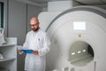 Doctor with a patient medical card near MRI scanner in a hospital Royalty Free Stock Photo