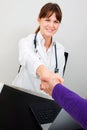 Doctor and patient shake hands
