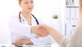 Doctor and patient shaking hands to each other. Healthcare, medicine and trusting concept Royalty Free Stock Photo