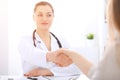 Doctor and patient shaking hands to each other. Healthcare, medicine and trusting concept Royalty Free Stock Photo