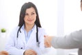 Doctor and patient shaking hands to each other. Healthcare, medicine and trusting concept Royalty Free Stock Photo