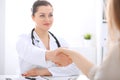 Doctor and patient shaking hands to each other. Healthcare, medicine and trusting concept Royalty Free Stock Photo