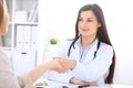 Doctor and patient shaking hands to each other. Healthcare, medicine and trusting concept Royalty Free Stock Photo