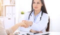 Doctor and patient shaking hands to each other. Healthcare, medicine and trusting concept Royalty Free Stock Photo