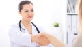 Doctor and patient shaking hands to each other. Healthcare, medicine and trusting concept. Royalty Free Stock Photo