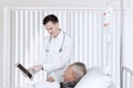 Doctor and patient with tablet in recovery room