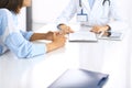 Doctor and patient talking and discussing health treatment while sitting at the desk, close-up. Medicine and health care Royalty Free Stock Photo