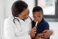 Doctor or pediatrician with baby patient at clinic Royalty Free Stock Photo