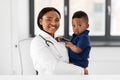 Doctor or pediatrician with baby patient at clinic Royalty Free Stock Photo