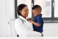 Doctor or pediatrician with baby patient at clinic Royalty Free Stock Photo