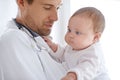 Doctor, pediatrician and holding baby for healthcare assessment, medical support and growth. Newborn kids, man and