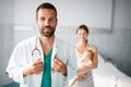 Doctor pediatrician with mother and baby child in clinic. Hospital, examining, child concept. Royalty Free Stock Photo