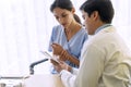 Doctor with pen and stethoscope sitting in office while talking about problem health patient woman fell friendly