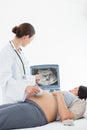 Doctor performing ultrasound on pregnant woman Royalty Free Stock Photo