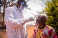 A doctor performs a coronavirus test with a swab on an elderly African patient. Covid-19 test in africa