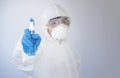 Doctor in personal protective equipment or PPE. holding alcohol spray bottle Royalty Free Stock Photo