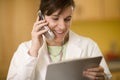 Doctor on phone reading medical records Royalty Free Stock Photo