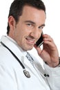 Doctor on phone smiling
