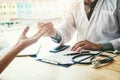 Doctor or physician writing diagnosis and giving a medical prescription to female Patient Royalty Free Stock Photo