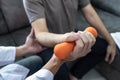 Doctor physiotherapist treating arm pain patient doing physical therapy exercises with his therapist in clinic - sport physical Royalty Free Stock Photo