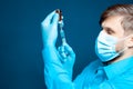 Doctor picks up a syringe for injecting a vaccine