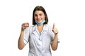 Doctor with pills giving thumb up. Royalty Free Stock Photo