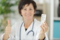 doctor with pills showing thumb up Royalty Free Stock Photo