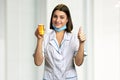 Doctor with pills showing thumb up. Royalty Free Stock Photo