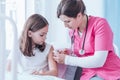 Doctor in uniform giving an injection to a child in hospital