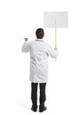 Doctor with placard over white